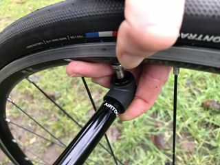 Image shows a rider using the Specialized Air Tool Road mini pump
