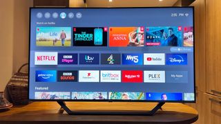 Hisense A7G review - Vidaa U menu on a TV placed on a wooden table
