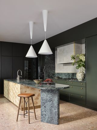 green kitchen with modern island and seating