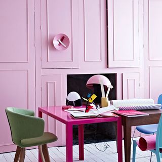room with pink cupboards and wooden flooring