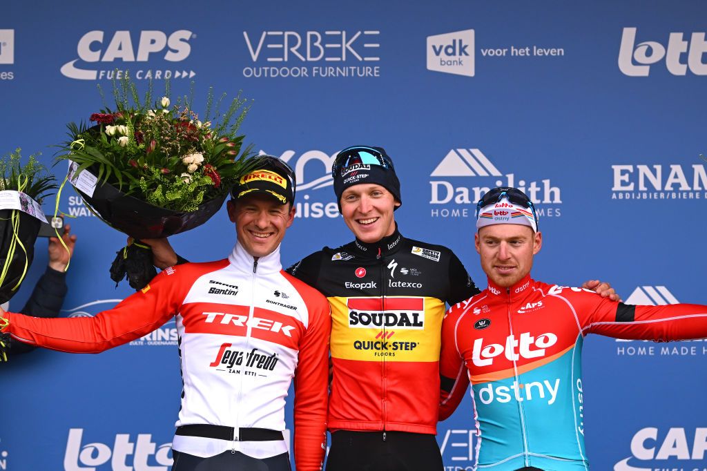NOKERE BELGIUM MARCH 15 LR Edward Theuns of Belgium and Team Trek Segafredo on second place race winner Tim Merlier of Belgium and Team Soudal Quick Step and Milan Menten of Belgium and Team Lotto Dstny on third place pose on the podium ceremony after the 77th Danilith Nokere Koerse 2023 Mens Elite a 1936km one day race from Deinze to Nokere DanilithNokereKoerse on March 15 2023 in Deinze Belgium Photo by Luc ClaessenGetty Images