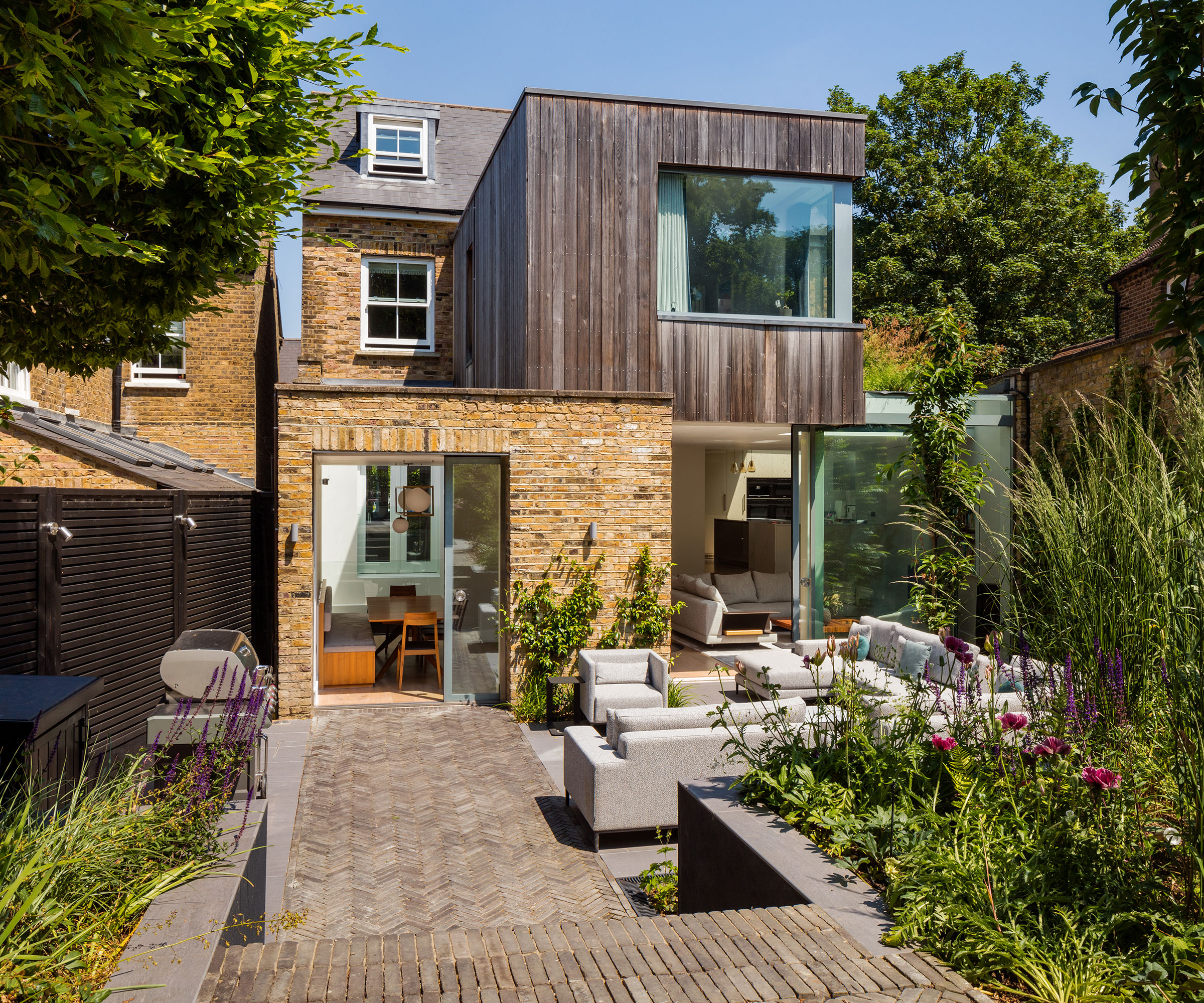 modern two storey extension with timber cladding a wraparound windows