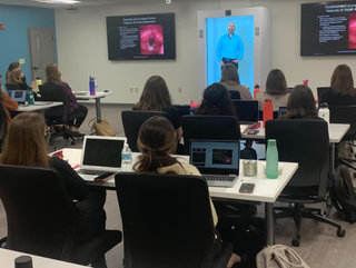 An expert delivers a health class via hologram