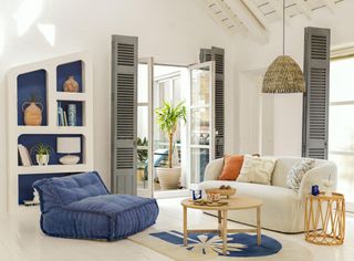 white living room with blue accents, white flooring, modern furniture, vaulted ceiling, gray shutters