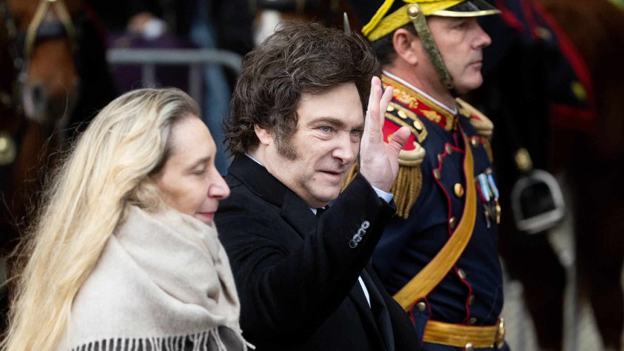 Argentina's President Javier Milei waves next to his sister, Secretary General of the Presidency Karina Milei
