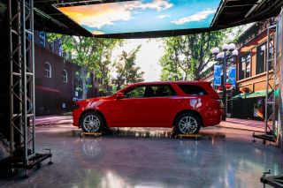 A red SUV in front of a Planar video wall making it appear to be outside in a virtual reality studio.