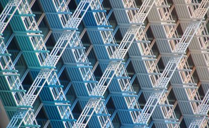 Exterior facade of an office building featuring vertical and horizontal lattice-type panels