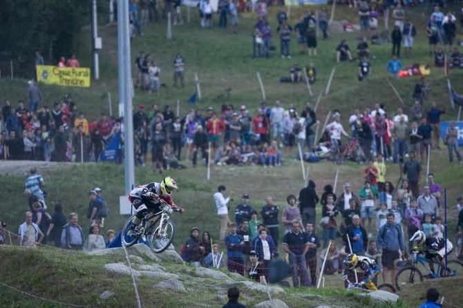 A four cross rider flies down the track