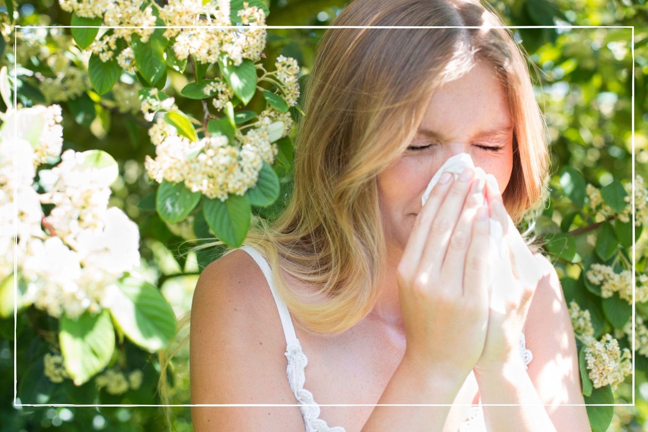 Woman blowing nose on tissue