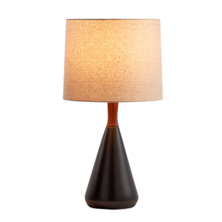 table lamp with stout circular base and tall rattan drum shade