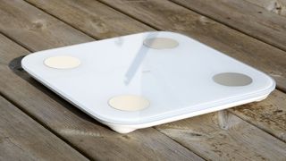 Xiaomi Mi Body Composition Scale 2 on a wooden floor
