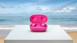 The Urbanista Earbuds at the beach in front of the sea