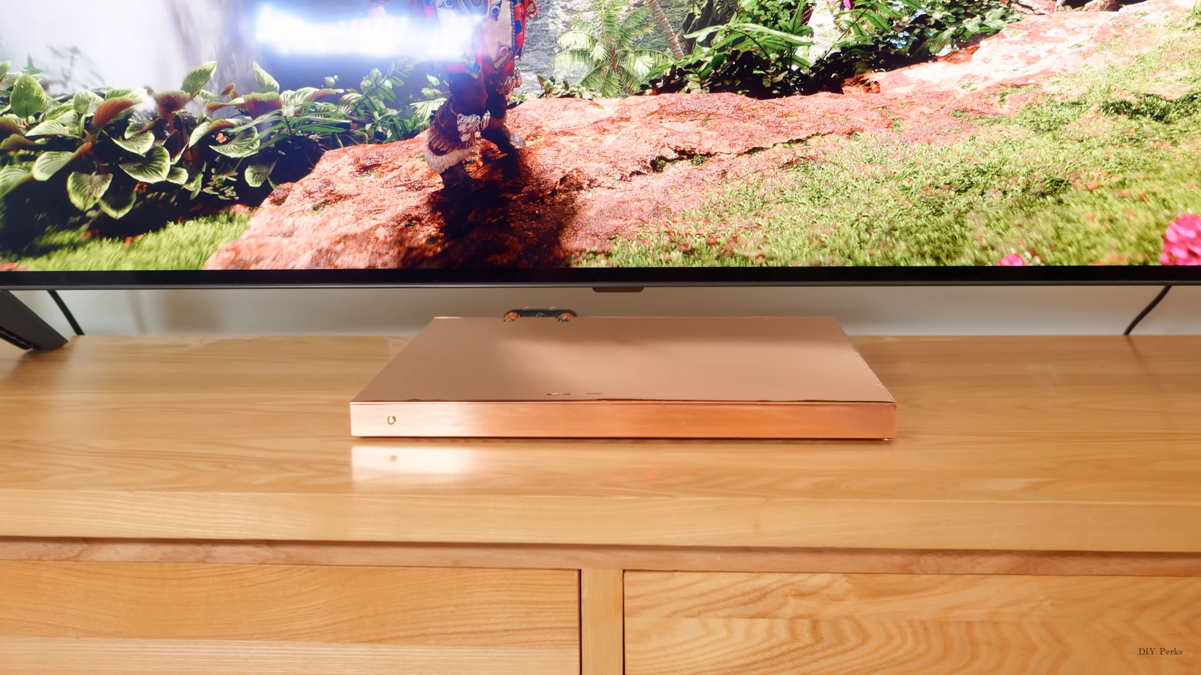 DIY PS5 Slim hides a water-cooling brick behind a TV cabinet