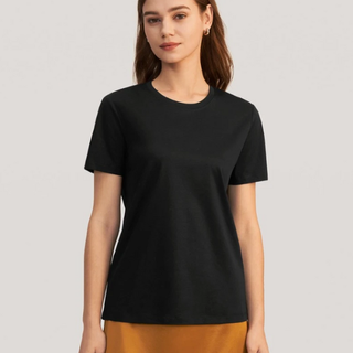 A woman wearing a black Lily Silk T-shirt, perfect for knowing how to style jeans