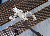 Dextre, also known as the Special Purpose Dextrous Manipulator (SPDM), is seen in the grasp of the International Space Station's robotic arm while Space Shuttle Endeavour is docked with the station. 