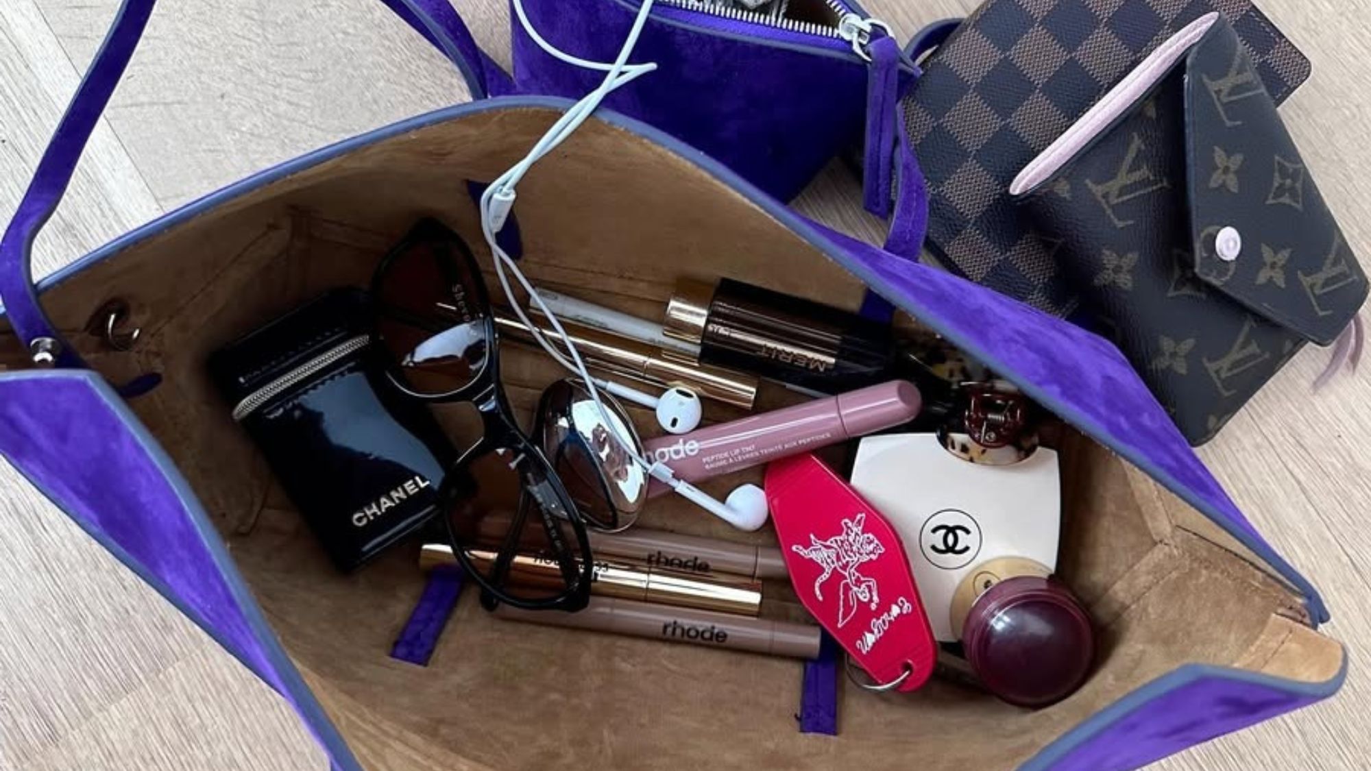 Rachelle Rowlings’ travel bag full of Chanel, Rhode, and Merit makeup.