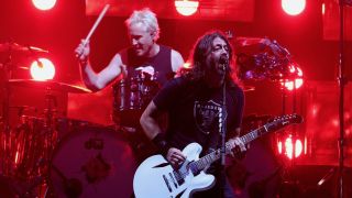 Dave Grohl and Josh Freese perform on stage