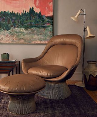 A leather swivel chair and ottoman