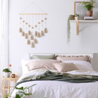 white bedroom with wall hangings