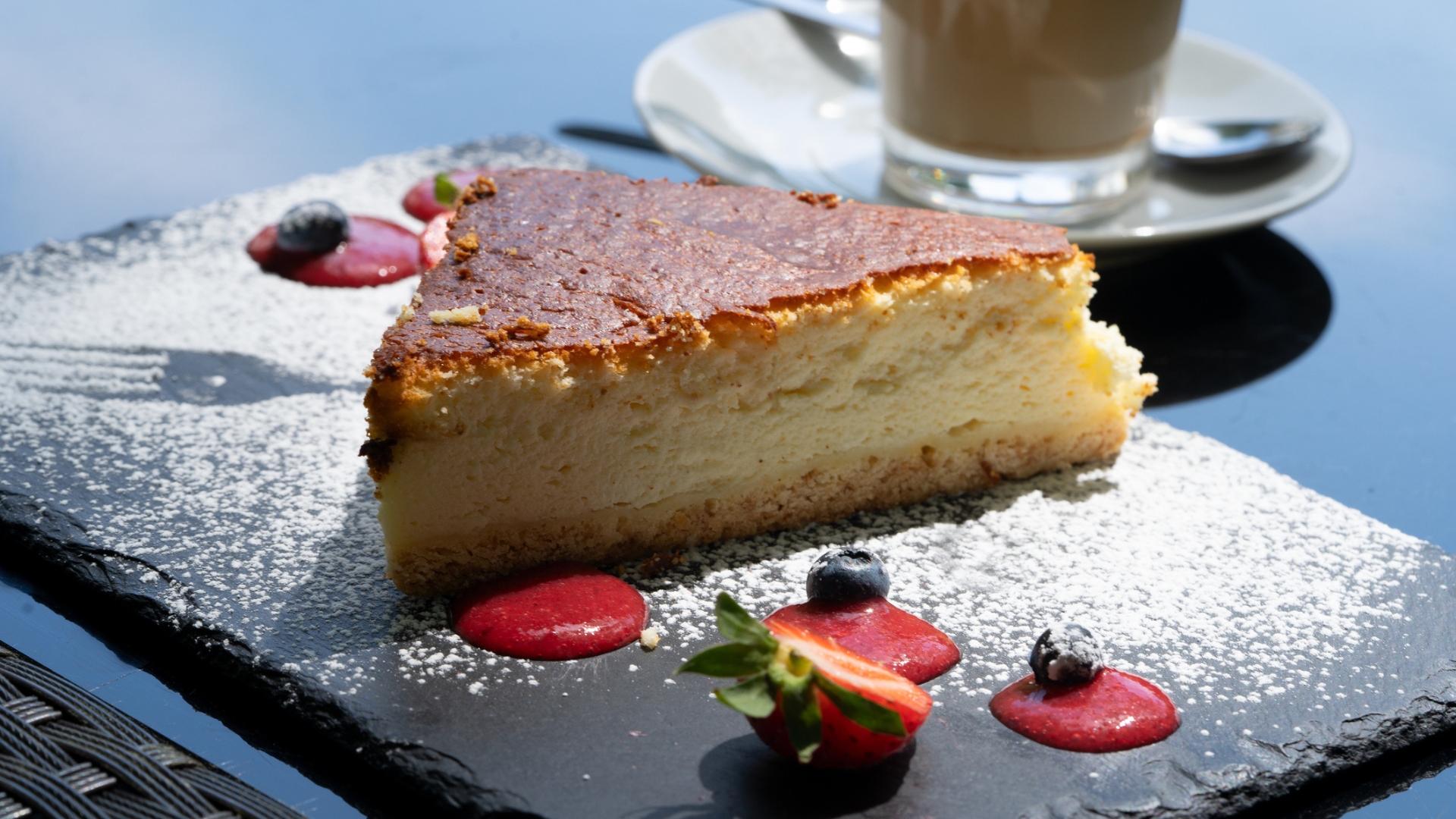 A slice of Sernik on a slate plate