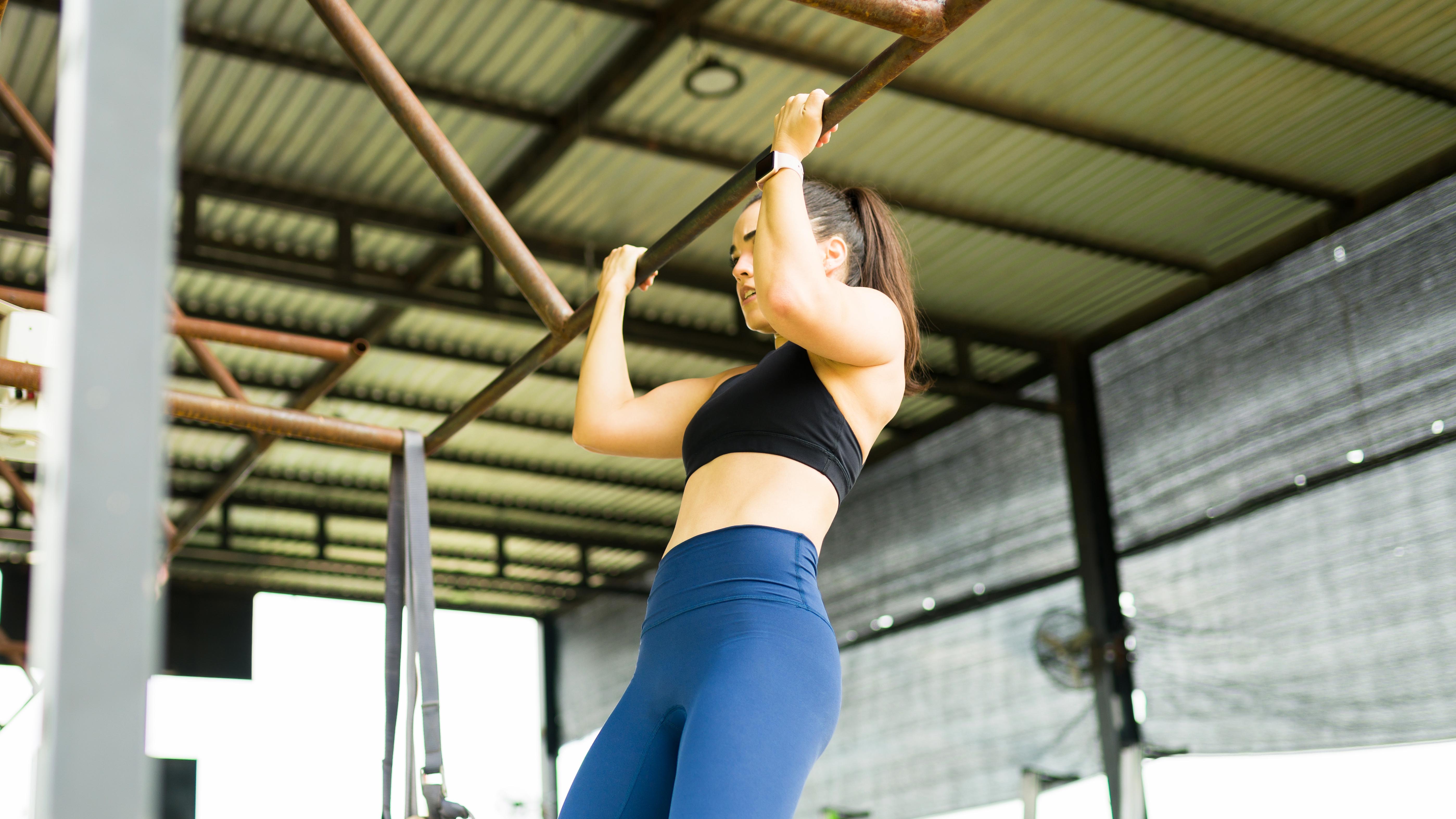 a woman doing a chin up