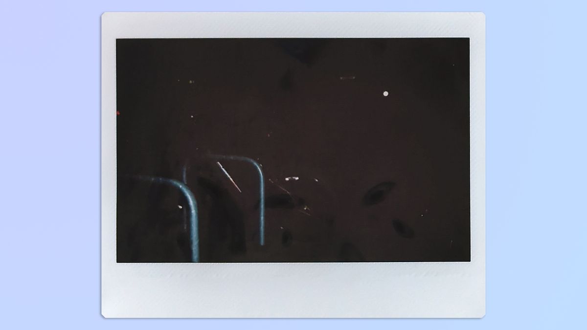 A photo of a bike taken at night, taken on a Fujifilm Instax Wide 400 instant camera