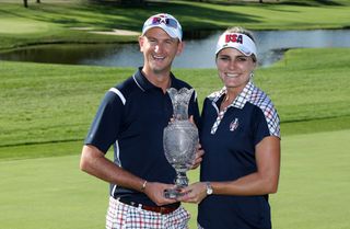 Team USA star Lexi Thompson and her caddie Kevin McAlpine hold up the Solheim Cup in 2017