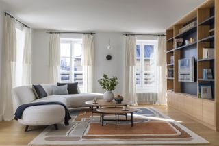 white curved sofa with joinery and TV unit