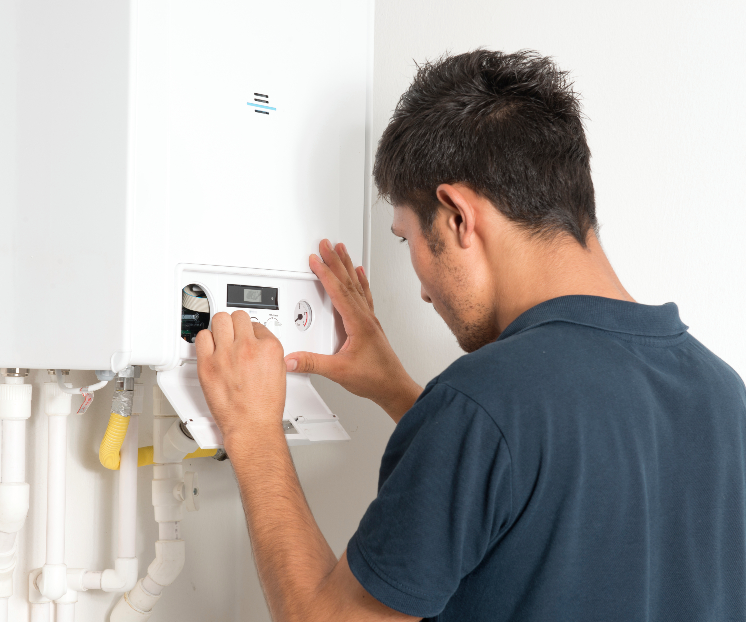 technician pressing reset buttons on front of boiler