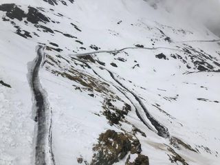 Snow plough have worked to clear the road on the Passo Gavia