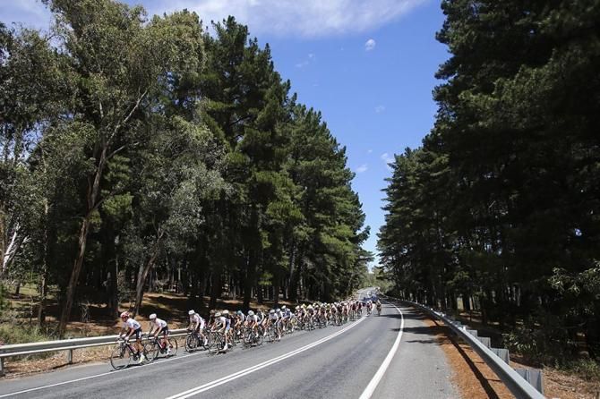 The peloton head towards the hills