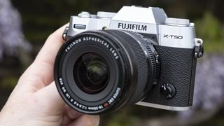 Fujifilm X-T50 camera in the hand with lens attached