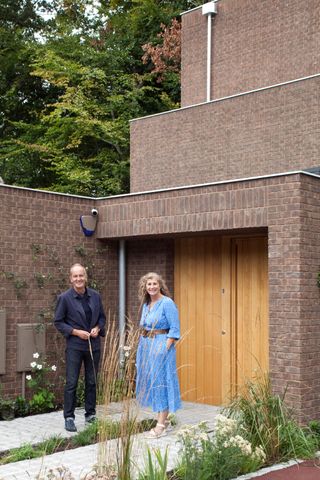 Corinne and Kevin McCloud outside the triangle shaped home