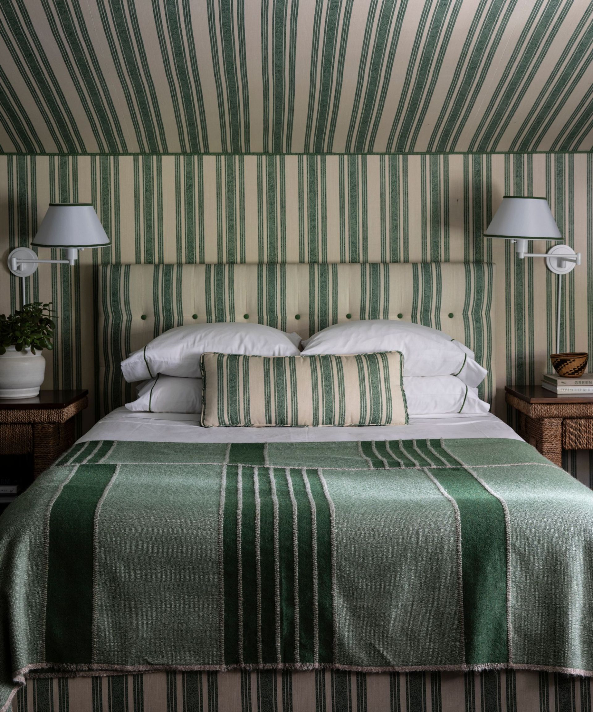 Green striped bedroom with wallpaper, throw and headboard