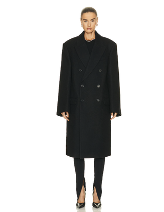 a model wearing a black overcoat