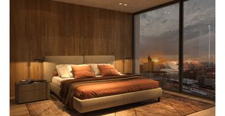 modern bedroom with glass doors looking out onto a sunset view with soft mood lighting inside to highlight how to make a bedroom cosy