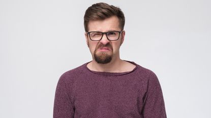 A man's facial expression looks very annoyed.