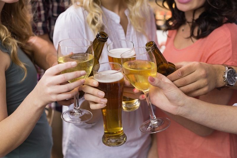 A group of friends drinking beer and wine.