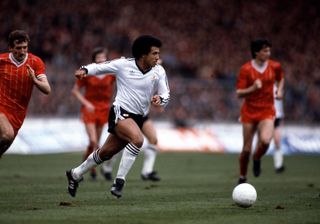 Remi Moses brings the ball forward for Manchester United in the 1983 Milk Cup final against Liverpool.