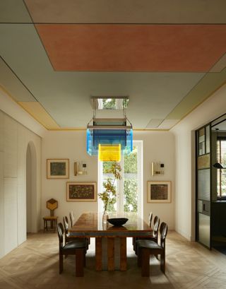 Dining room with neutral walls and painted ceiling and dining table and chairs