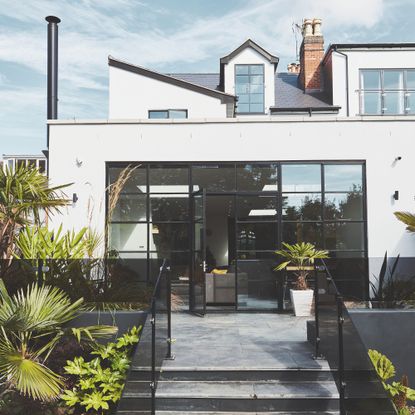 Crittall-style patio doors and fixed glazing Modernist-style extension