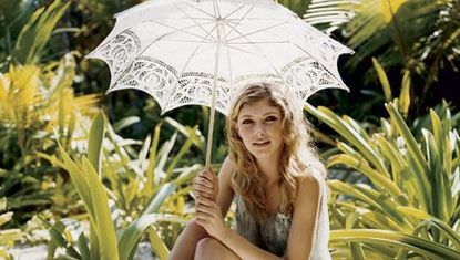 girl on beach with umbrella