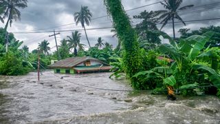 A house in the Philippines is submerged in water after torrential rain and flooding.