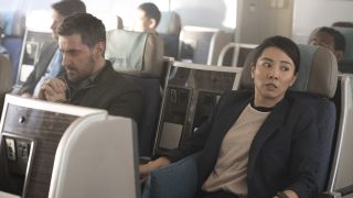 Dr Matthew Nolan (Richard Armitage), in handcuffs, sits alongside a panicked looking DC Hana Li (Jing Luci) aboard an passenger plane in Red Eye