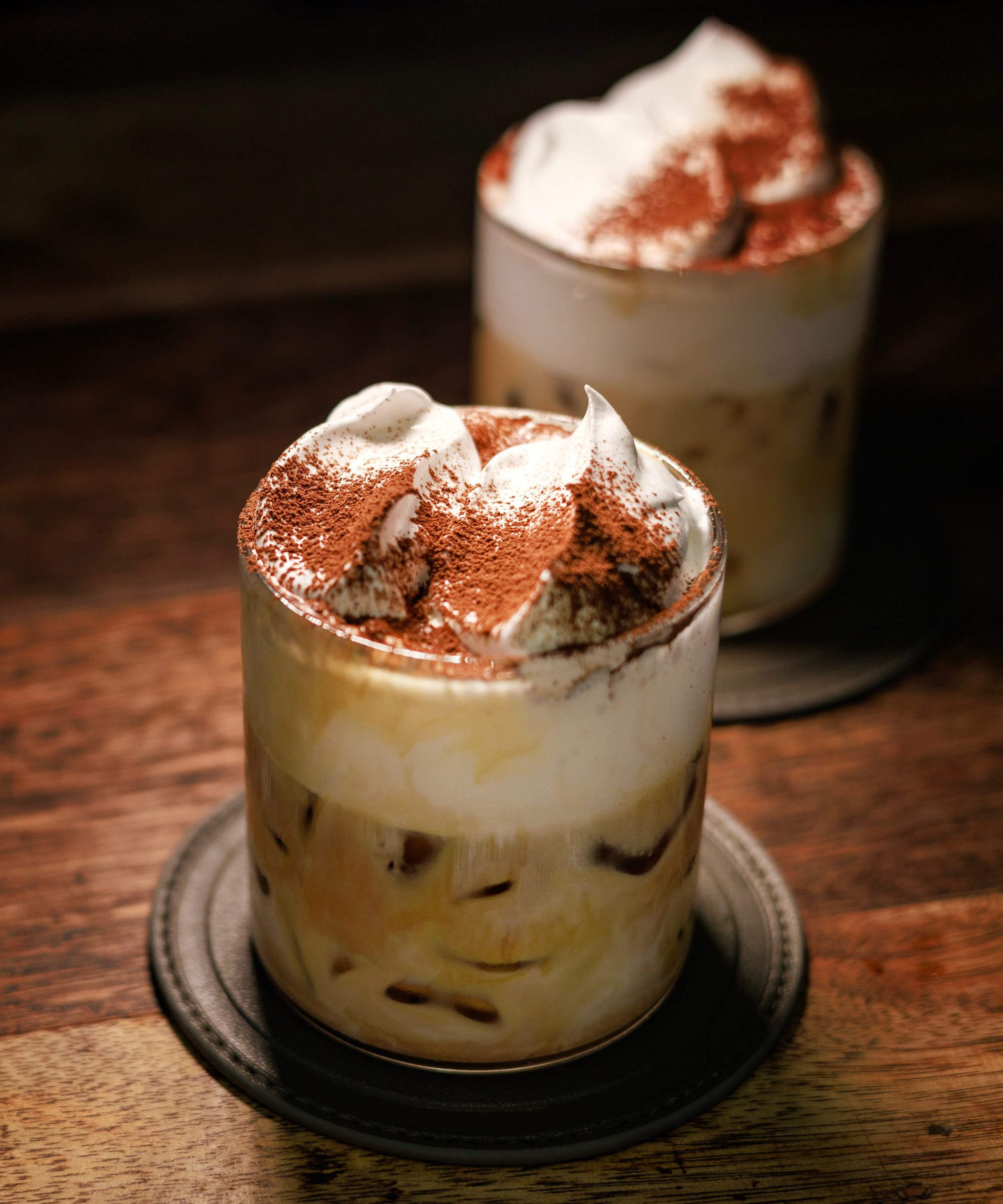 Iced coffee with a dusting of cocoa