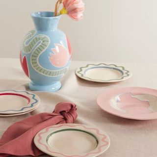 Plates in pink and blue and green with vase