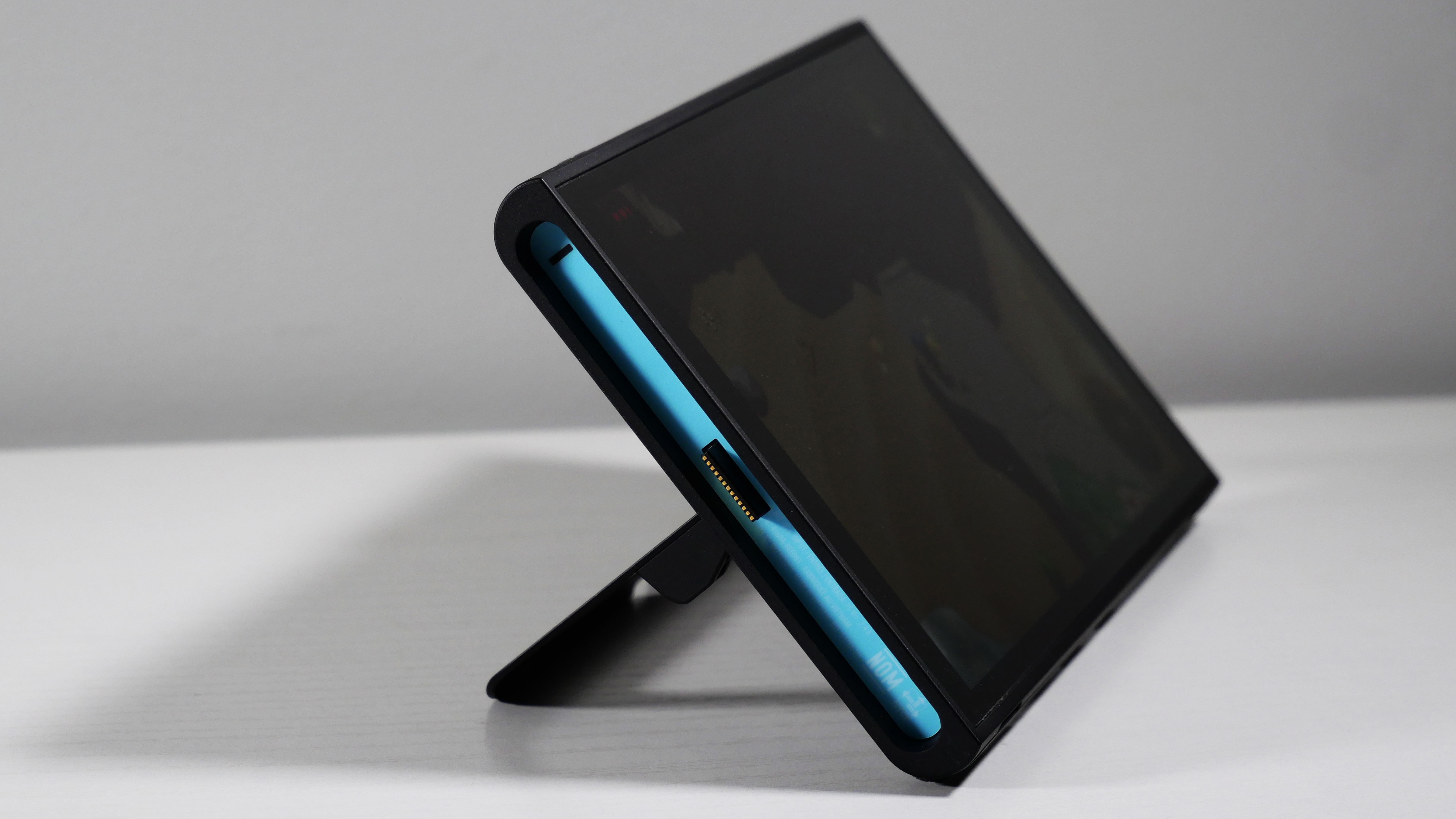 Nintendo Switch 2 standing on a white desk, highlighting the Joy-Con 2 Port.