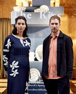 London-based design studio Glithero's Sarah van Gameren and Tim Simpson, standing in front of their sponge totem 