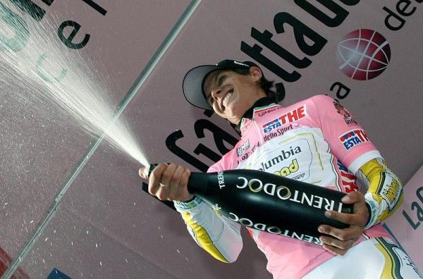 Thomas L&ouml;vkvist is all smiles as he uncorks the champagne on the podium.