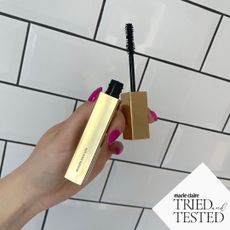 Lucy Abbersteen holding Vieve Modern mascara up against white tiles